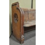 A Victorian pine pew, both ends carved with a quatrefoil,