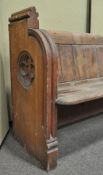 A Victorian pine pew, both ends carved with a quatrefoil,