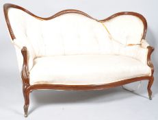 A Victorian mahogany show frame sofa with serpentine button back on cabriole legs