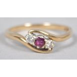A yellow metal dress ring principally set with a round faceted cut ruby