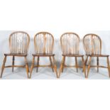 A set of four reproduction Windsor style chairs each with a pierced splat,