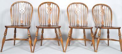 A set of four reproduction Windsor style chairs each with a pierced splat,