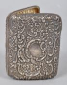 A silver cigarette case, extensively repousse decorated with c scroll floral decoration, 9cm x 7cm