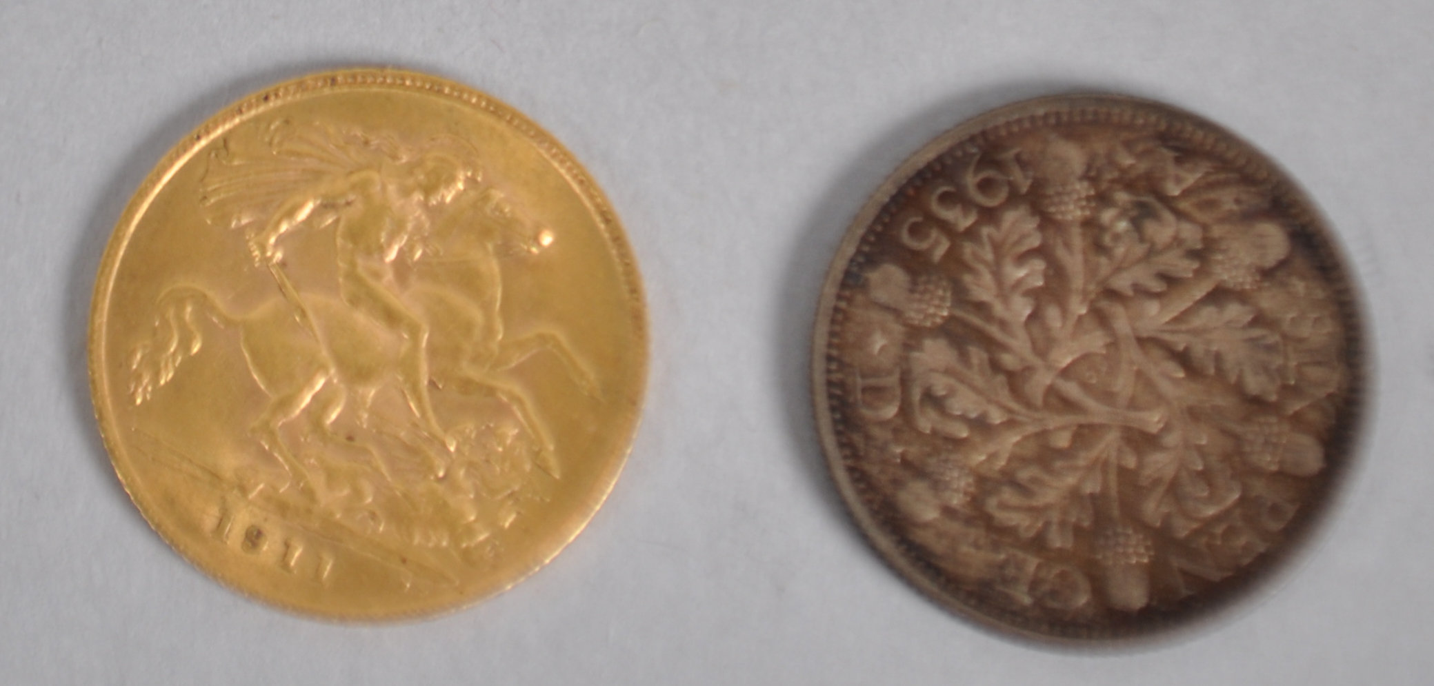 A half sovereign coin dated 1911 together with a silver sixpence coin dated 1935. - Image 2 of 3