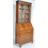 A George III style bureau bookcase with an astragal glazed bookcase above a fall front desk