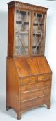 A George III style bureau bookcase with an astragal glazed bookcase above a fall front desk