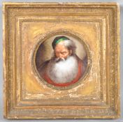 A 19th century circular porcelain plaque painted in enamels with a bearded elderly gentleman,