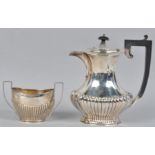 A silver coffee jug, of shaped baluster form, with a ribbed base and cover,