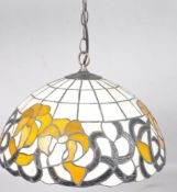 A leaded glass Tiffany style pendant light shade with stylised trailing yellow flowers