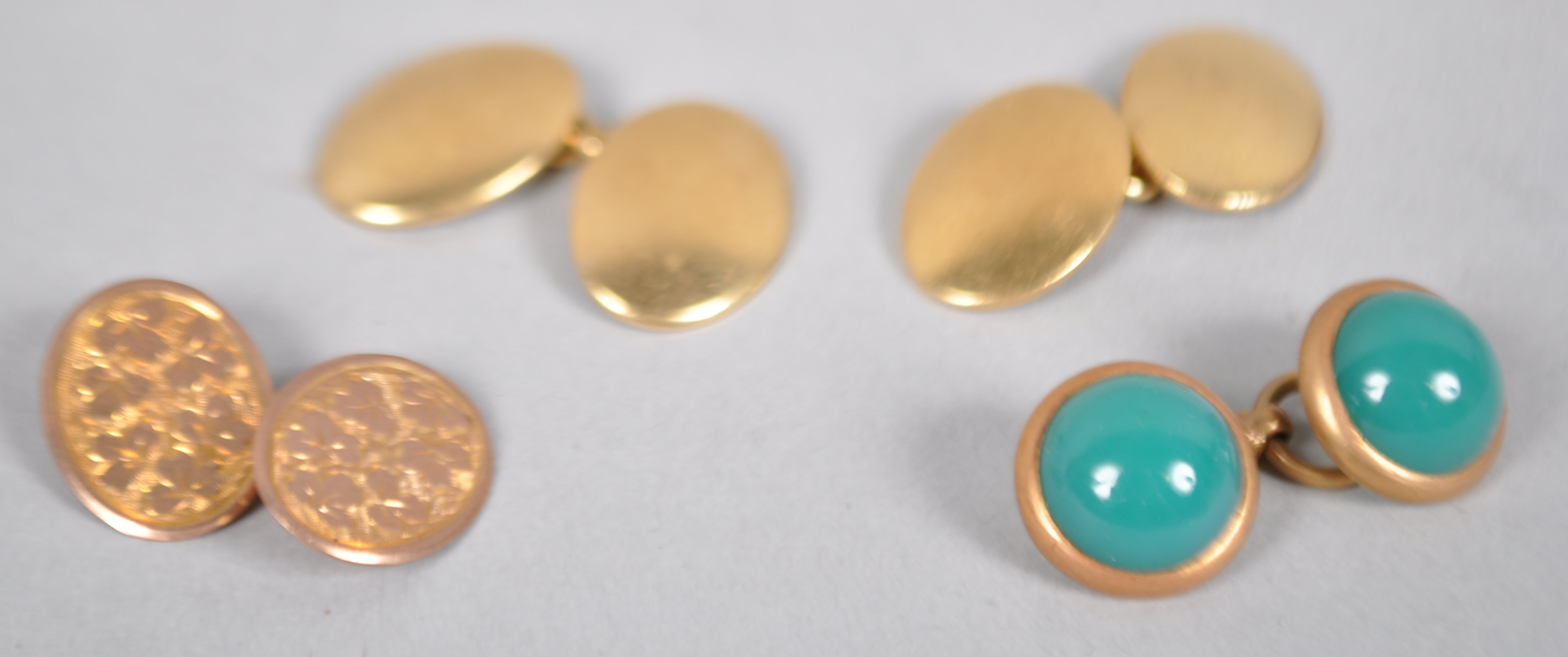 A pair of yellow metal cufflinks stamped 18ct together with two single cufflinks.