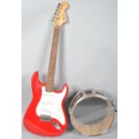 A Red Square strat Fender electric guitar and a Percussion Plus snare drum