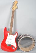 A Red Square strat Fender electric guitar and a Percussion Plus snare drum