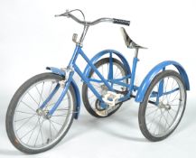 A vintage child's tricycle, the blue painted frame with vinyl seat,
