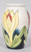 A small Moorcroft pattern tube lined vase,