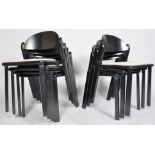 A set of seven 1970's black lacquered stacking chairs, with drop in seats,