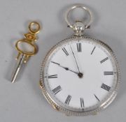 An open faced pocket watch having a silver engraved case. Circular dial with Roman numeral.