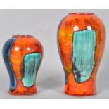 A Poole pottery gemstone vase of baluster form, with typical bright decoration on an orange ground,