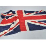 A large linen Union Jack ensign, World War II era with wooden toggle and rope,