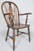 An elm Windsor chair with spindle and wheel splat on turned baluster legs, 103cm high,