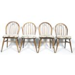 Four Ercol dark beech and Elm dining chairs with stick backs on splayed legs