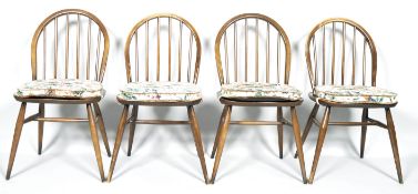 Four Ercol dark beech and Elm dining chairs with stick backs on splayed legs