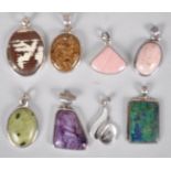 A collection of eight large pendants set with varying gemstones.
