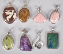 A collection of eight large pendants set with varying gemstones.