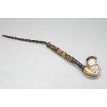 A 19th century Continental porcelain pipe, with floral decoration and brass mounts,
