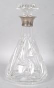 A cut glass decanter and stopper with silver collar, hallmarked London 1962