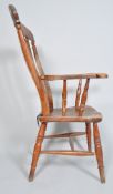 A 19th century Victorian elm farmhouse chair with tall rail back, scrolled arms and saddle seat,
