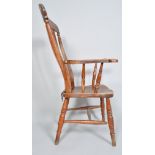 A 19th century Victorian elm farmhouse chair with tall rail back, scrolled arms and saddle seat,