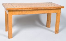 A rectangular oak coffee table, the top inlaid with box wood and ebony, on square legs,