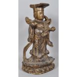 A Chinese carved wood and painted figure of an immortal, on double lotus base,