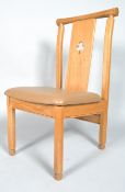 A modern oak dining chair, the splat pierced with a trefoil,
