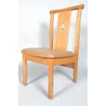 A modern oak dining chair, the splat pierced with a trefoil,