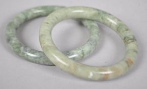 A pair of mottled jade bangles