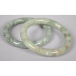 A pair of mottled jade bangles