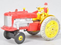 A combination tin plate battery operated reversible tractor toy,