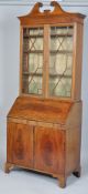 An Edwardian mahogany inlaid bureau bookcase in George III style,