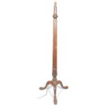 A mahogany standard lamp, the gadrooned stem above stylised leaf and tripod base, on cabriole legs,
