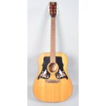 A K550 acoustic guitar, with black white and red bird and flower mot with pegs,
