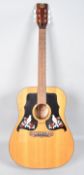 A K550 acoustic guitar, with black white and red bird and flower mot with pegs,