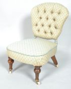 A Victorian button back nursing chair on turned mahogany legs on brass and ceramic casters,