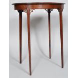 An Edwardian mahogany oval occasional table with pierced brackets to the slim square tapering legs,