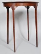 An Edwardian mahogany oval occasional table with pierced brackets to the slim square tapering legs,