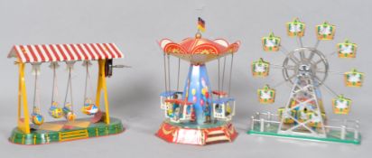 Two modern German Nornberger Blechspielzeug tinplate fairground model toys, the carousel, 22cm high,