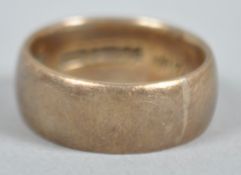 A yellow metal 7.5mm D shape wedding ring. Hallmarked 9ct gold, Birmingham, 1959.