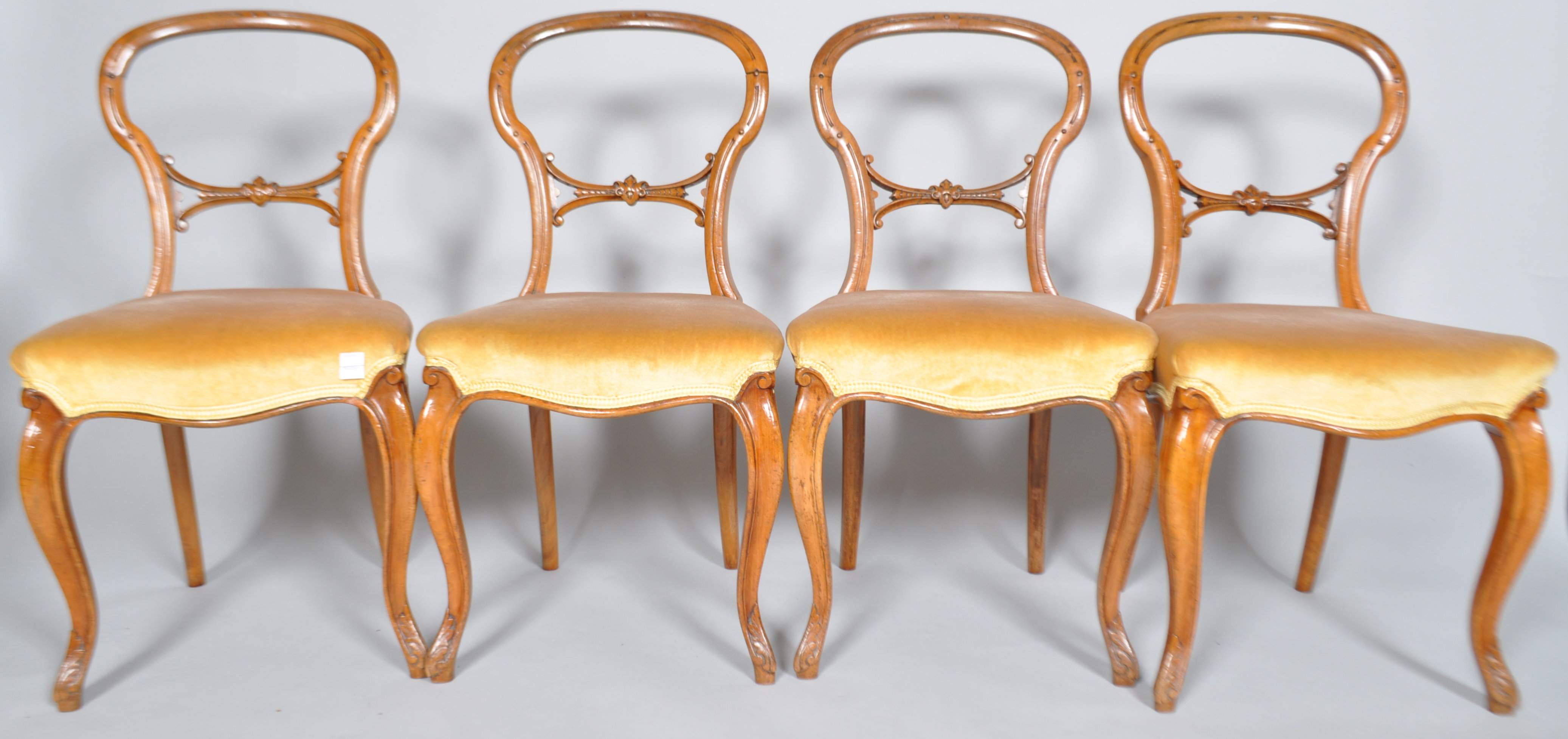 A set of four Victorian mahogany balloon back dining chairs,