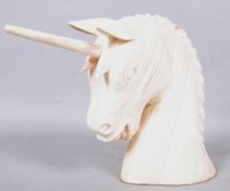 A modern, artisan carved pine bust of a unicorn with flowing mane,