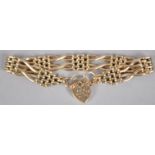 A yellow metal gate and brick link bracelet finished with a fancy heart shaped padlock clasp.